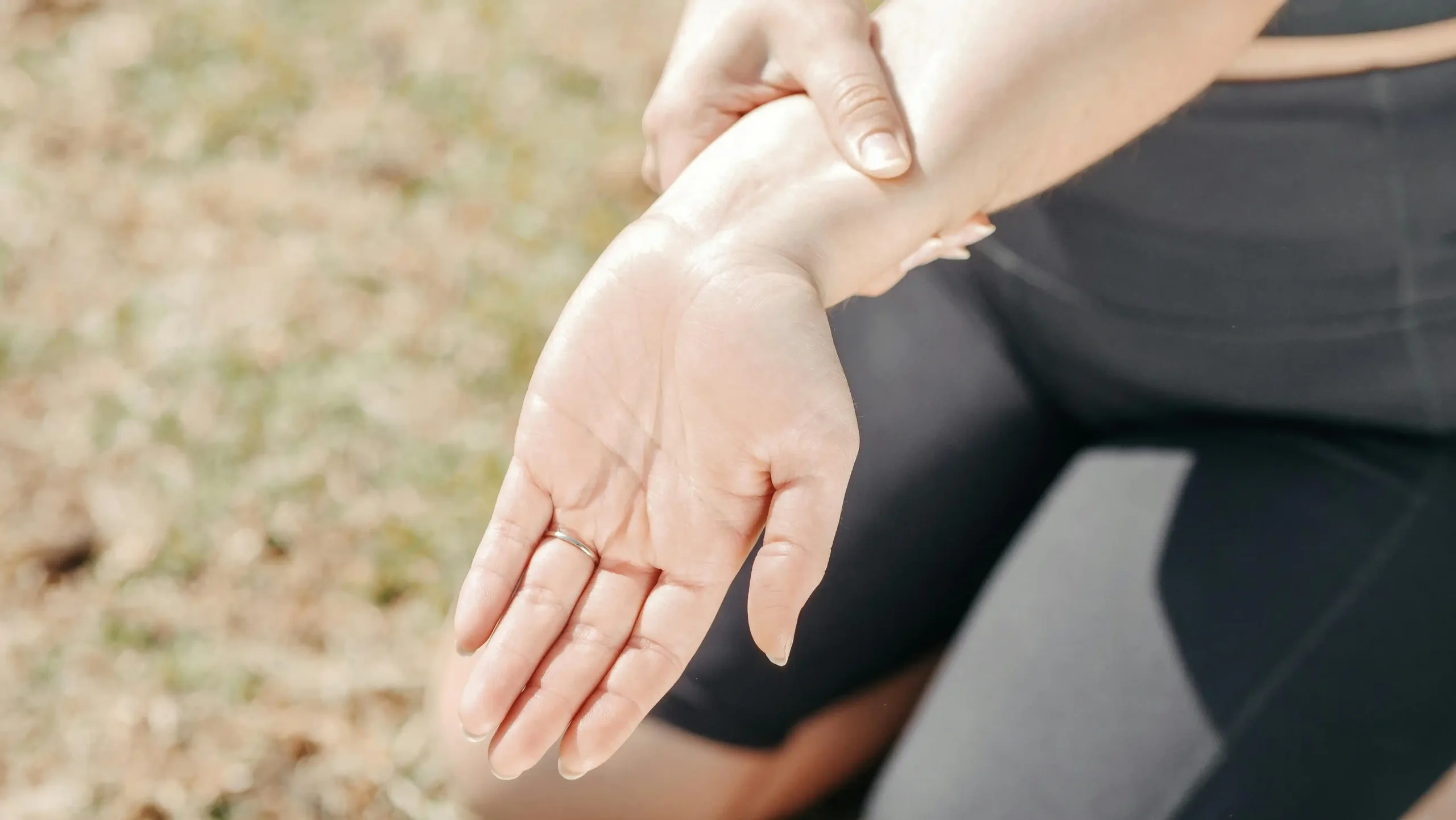 Person holding their wrist